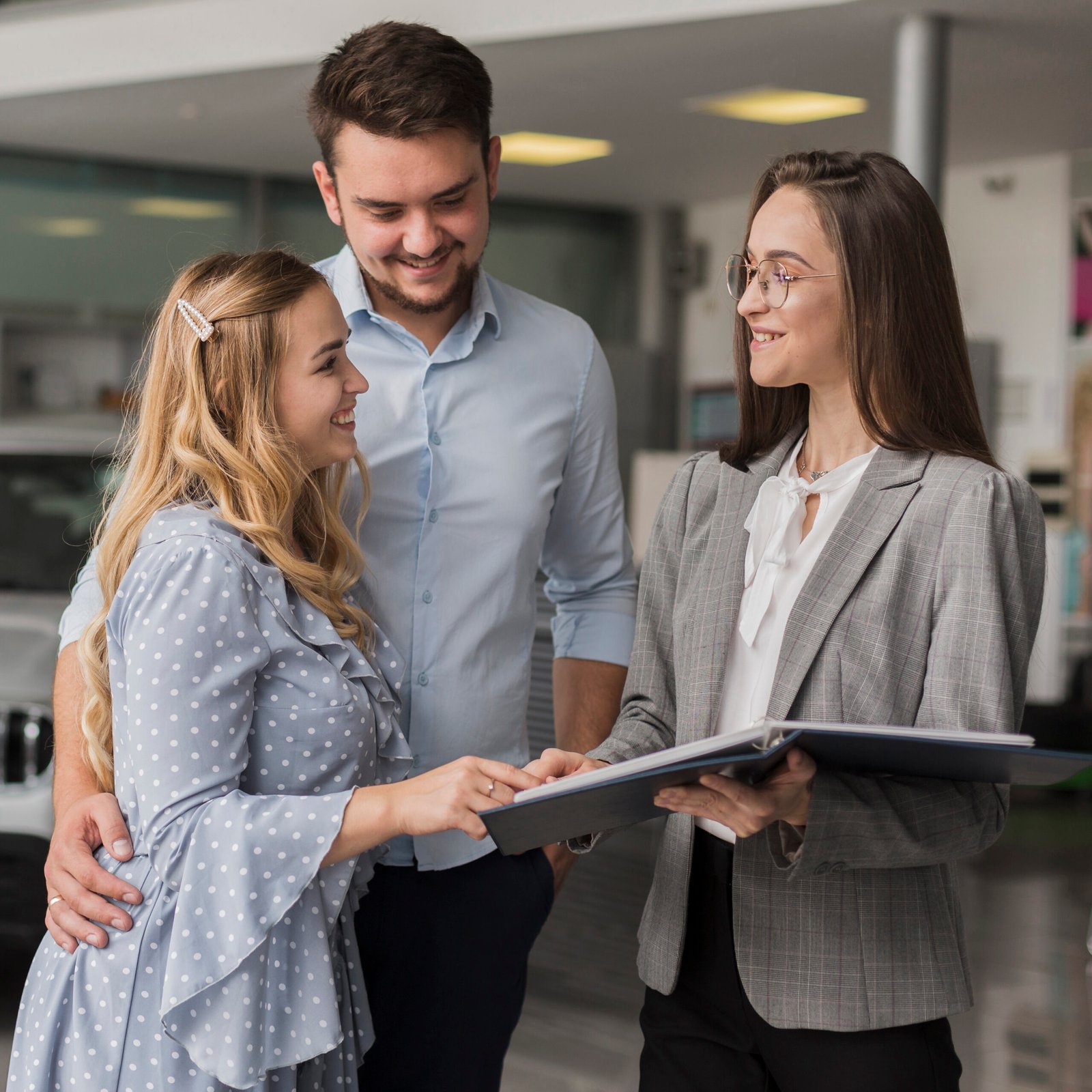 happy-couple-talking-with-car-dealer